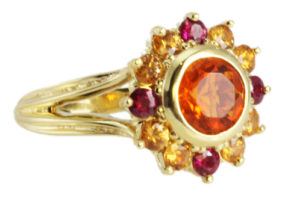 This 18k yellow gold Mexican fire opal ring bursts with energy.  The 0.90 carat fire opal is surrounded by orange and yellow sapphires (1.20 ctw). call for pricing (# 200-1928)
