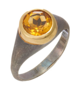 This oxidized sterling silver ring features a 1.9 carat round citrine set in an 18k yellow gold bezel. Call for pricing (#620-1385)
