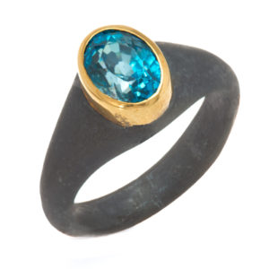 This oxidized sterling silver ring features an 8x6 amethyst set in an 18k gold bezel. Call for pricing (#620-1424)
