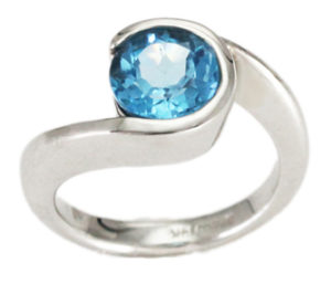 This 14k white gold by-pass style ring features a brilliant 7mm round Swiss blue topaz. Call for pricing (#200-01460)
