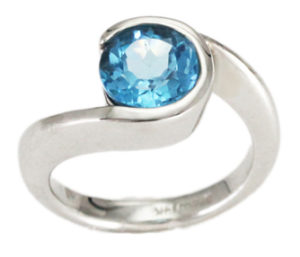This 14k white gold by-pass style ring features a brilliant 7mm round Swiss blue topaz. Call for pricing (#200-01460)
