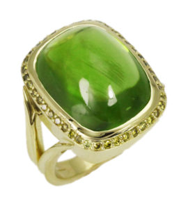 This luscious 14.05 carat peridot is set in 18k yellow gold and is surrounded by 0.39 ctw of yellow diamonds.  Call for pricing (#200-1454)


