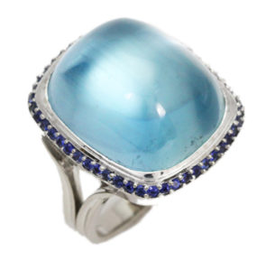 This spectacular 27 carat aquamarine is set in 18k yellow gold and surrounded by blue sapphires. Call for pricing (#200-1456)

