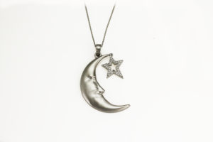 This jovial moon face, created in 18k white gold, is adorned by a constantly sparkling diamond star.  The pendant is approximately 1 ¼” in length and looks wonderful on a 24” chain.  Call for pricing (#437-00394)