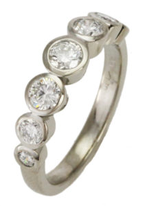 This classic band, featuring five bezel set diamonds, is lovely in rose, yellow or white gold. Call for pricing (# 130-01011)

