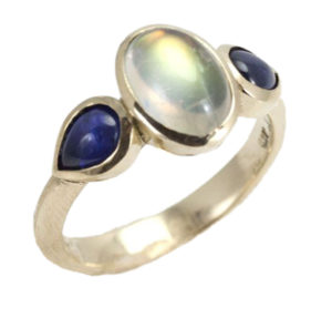 Wear a rainbow on your hand with this magical 14k gold ring featuring a 1.35 carat rainbow moonstone accented by two blue sapphires.  Call for pricing (#200-1602)

