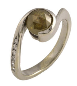 This 14k yellow gold by-pass style ring is set with a warm and inviting 1.13 carat rose  cut brown diamond. Call for pricing (#100-0405)
