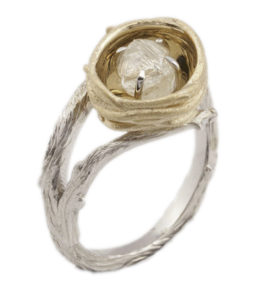 This whimsical 14k yellow and white gold ring is set with a 1 carat natural shape rough white diamond. call for pricing (#100-00448)
