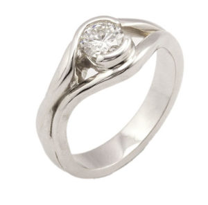 This sweet free form ring is set with a quarter carat round brilliant diamond. Call for pricing (#100-0400)
