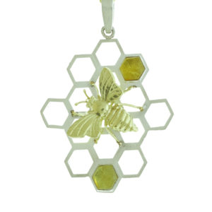 This whimsical 18k yellow gold bee sits on a sterling silver honeycomb set with amber.  The pendant is approximately 1 3/4″ in length and 1 1/2′ in width and will help you buzz through your day. Call for pricing (#635-1959)

