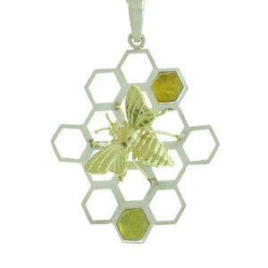 This whimsical 18k yellow gold bee sits on a sterling silver honeycomb set with amber.  The pendant is approximately 1 3/4″ in length and 1 1/2′ in width and will help you buzz through your day. Call for pricing (#635-1959)

