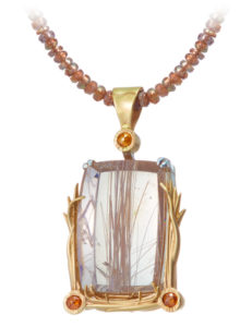 14k yellow gold and sterling silver rutilated quartz pendant strung on Andalusian garnets