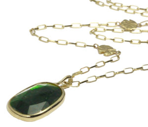 This 18k yellow gold pendant features a rose cut green tourmaline set in a beautiful bezel featuring a swimming koi on the reverse side.  The pendant is offered on a 24” open link chain. Call for pricing (#230-1192)